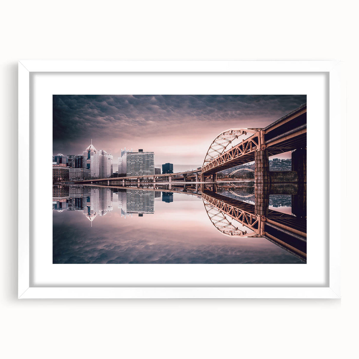 Abstract art print of the Pittsburgh skyline in muted gray and blue tones on a framed white mat, ideal for dining room decor.