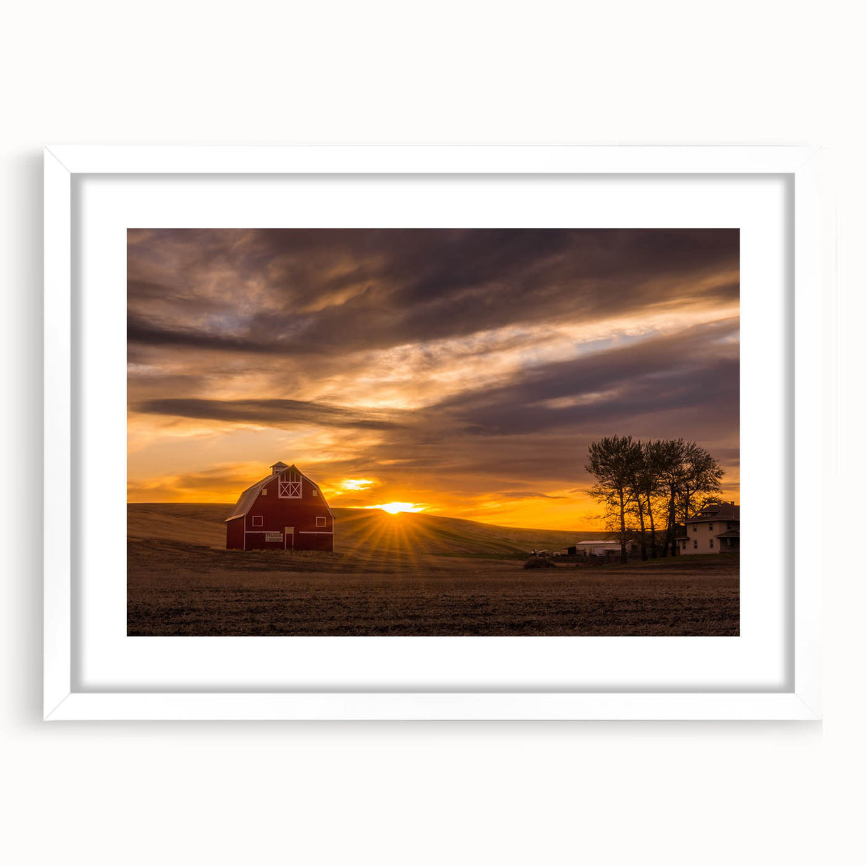 Abstract art print of rolling Palouse hills in soft green and blue tones, framed in white, suitable for dining room decor.