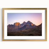 Framed landscape artwork showcasing dramatic cliffs and serene skies, featuring a sophisticated gold mat, perfect for enhancing home decor and artistry.