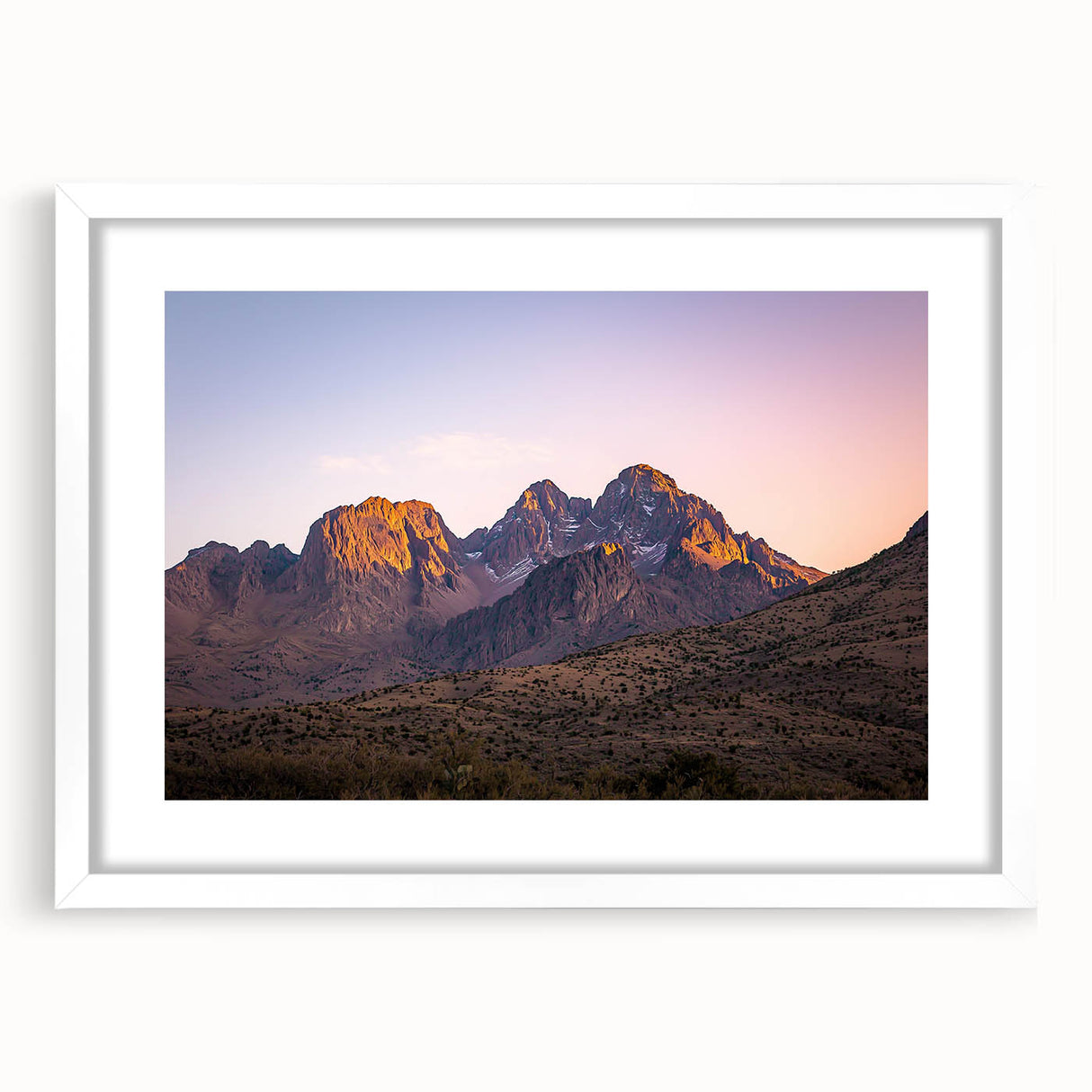 Framed landscape artwork showcasing dramatic cliffs against a vibrant sky, with a white mat and sleek frame, ideal for enhancing modern home decor.
