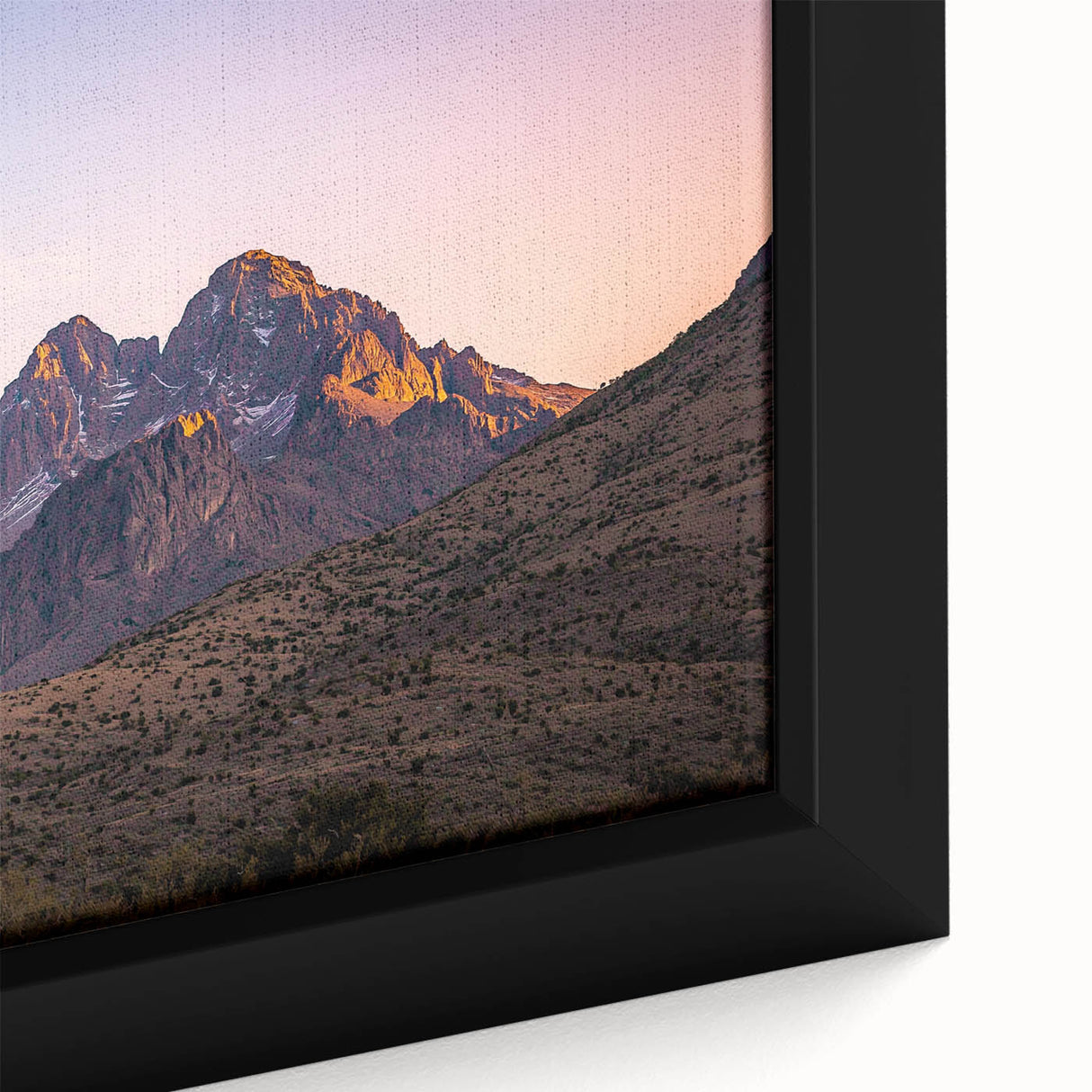 Close-up of a framed canvas artwork depicting a dramatic landscape with rugged cliffs, vibrant colors, and intricate details, ideal for modern home decor.