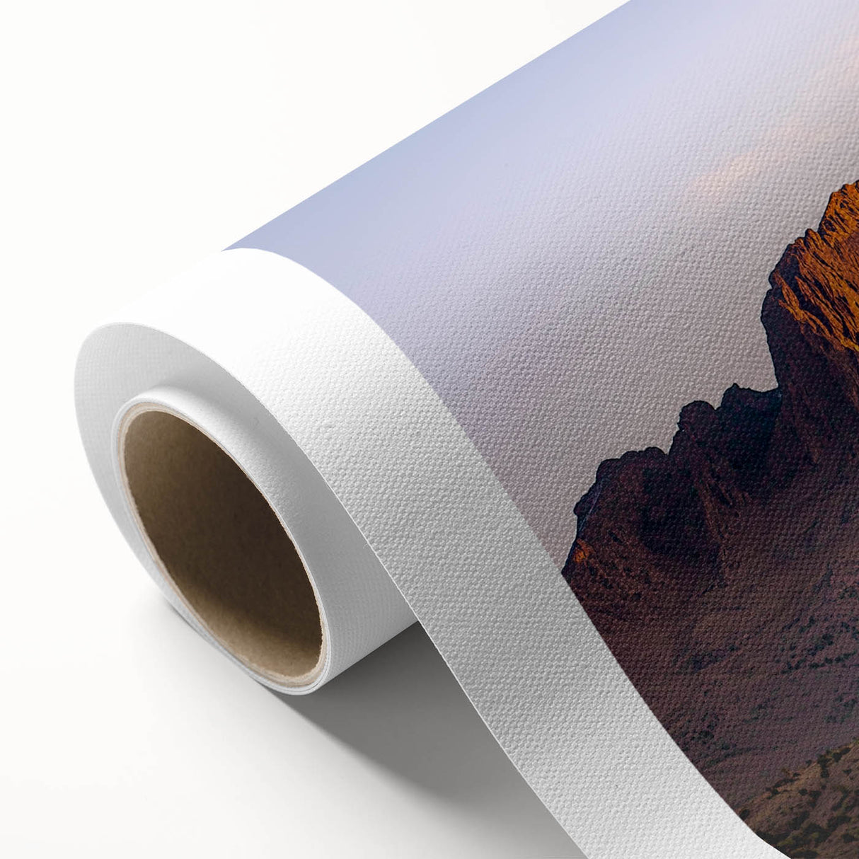 Rolled canvas artwork showcasing a vibrant landscape of rugged cliffs and serene skies, designed for wall decoration, securely packaged for delivery in a protective tube.