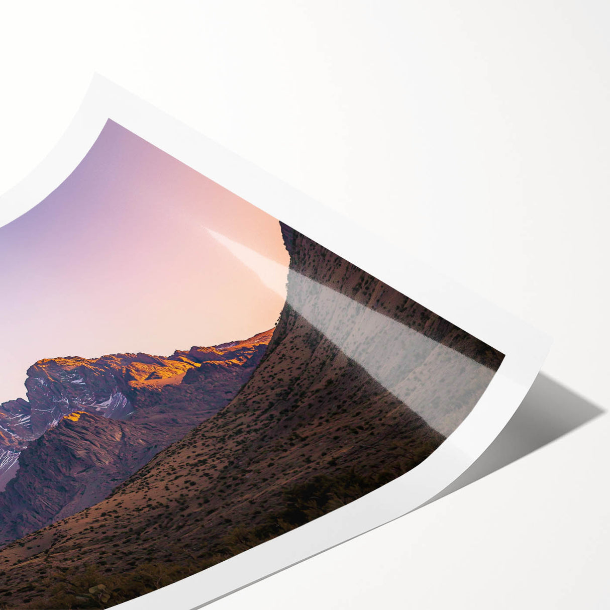 Vibrant rolled print showcasing a stunning landscape of dramatic cliffs against a sunset sky, ideal for home decor or art enthusiasts, securely packaged in a protective tube.