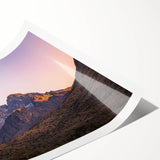 Vibrant rolled print showcasing a stunning landscape of dramatic cliffs against a sunset sky, ideal for home decor or art enthusiasts, securely packaged in a protective tube.