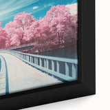 Close-up of a framed canvas print depicting a serene landscape bridge over a tranquil river, showcasing vibrant colors and intricate details, perfect for home decor.