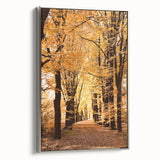 Landscape art painting featuring autumn trees in vibrant orange and yellow tones on a framed canvas.