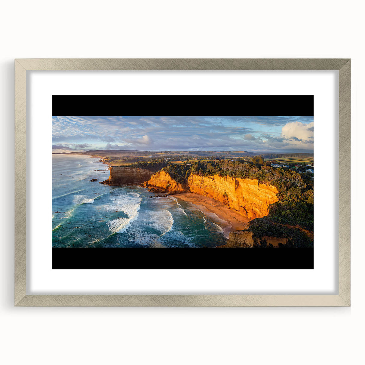Silver-framed landscape artwork showcasing rugged cliffs and serene skies, elegantly matted for a polished presentation, perfect for home decor enhancement.