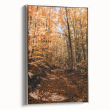 Framed canvas depicting a vintage-style landscape painting with autumnal trees in vibrant orange and red tones.