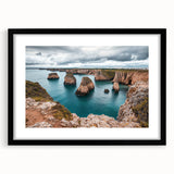 Black-framed landscape artwork depicting dramatic cliffs and ocean waves, elegantly matted for a sophisticated presentation in home decor.