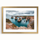 Elegant gold-framed landscape artwork depicting dramatic cliffs under a vibrant sky, enhanced with a white mat for a sophisticated presentation; perfect for home decor.