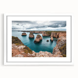 White-framed landscape artwork showcasing majestic cliffs under a clear sky, designed with a mat for an elegant presentation, perfect for home décor.