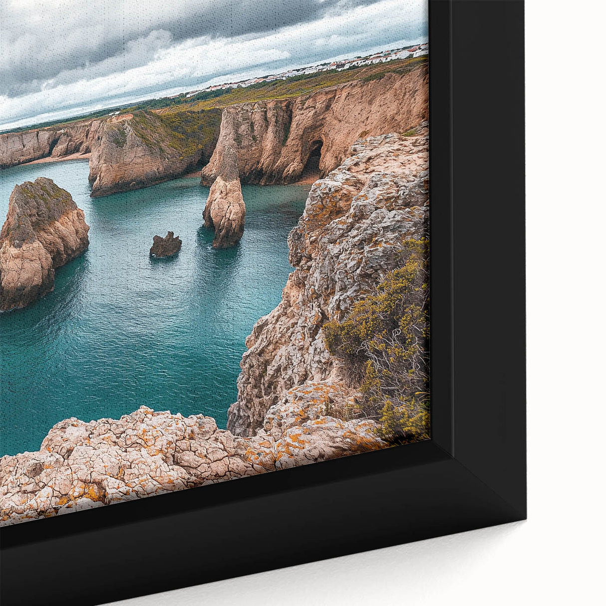 Close-up of a framed canvas artwork depicting a dramatic cliff landscape with vibrant colors and intricate details, perfect for enhancing home decor.