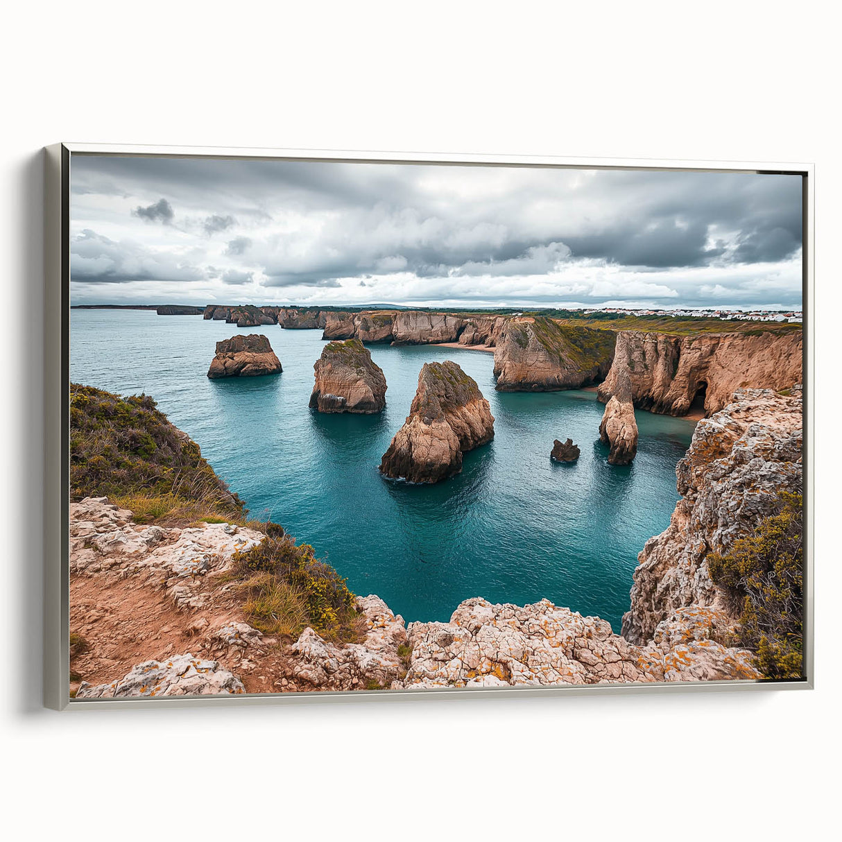 Framed canvas artwork depicting dramatic landscapes of steep cliffs, presented with a sleek silver frame, ideal for enhancing modern home decor.