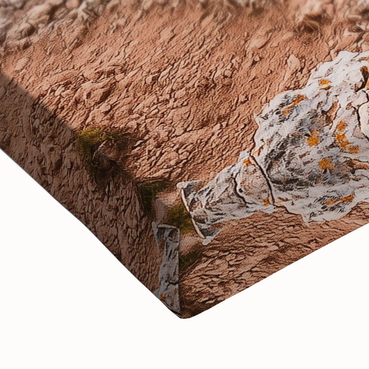 Close-up of a vibrant stretched canvas featuring a stunning landscape of cliffs under a bright blue sky, showcasing intricate textures and colors ideal for home décor.