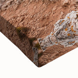 Close-up of a vibrant stretched canvas featuring a stunning landscape of cliffs under a bright blue sky, showcasing intricate textures and colors ideal for home décor.
