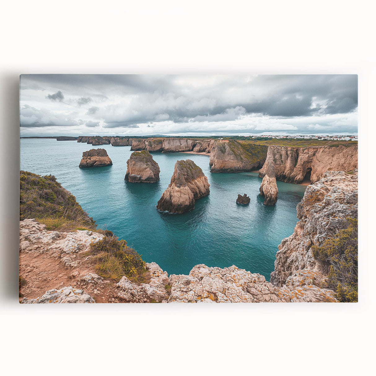 Stretched canvas artwork showcasing a dramatic cliff landscape at sunset, featuring vibrant oranges and deep blues, perfect for modern home decor and enhancing any space.