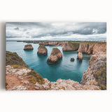 Stretched canvas artwork showcasing a dramatic cliff landscape at sunset, featuring vibrant oranges and deep blues, perfect for modern home decor and enhancing any space.