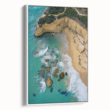 Framed canvas artwork depicting a dramatic landscape with towering cliffs and lush greenery, presented in a sleek white frame, ideal for modern home decor.