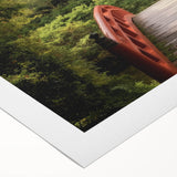 Rolled canvas showcasing a vibrant landscape bridge design, featuring rich colors and intricate details, packaged securely in a protective cardboard tube for shipping.