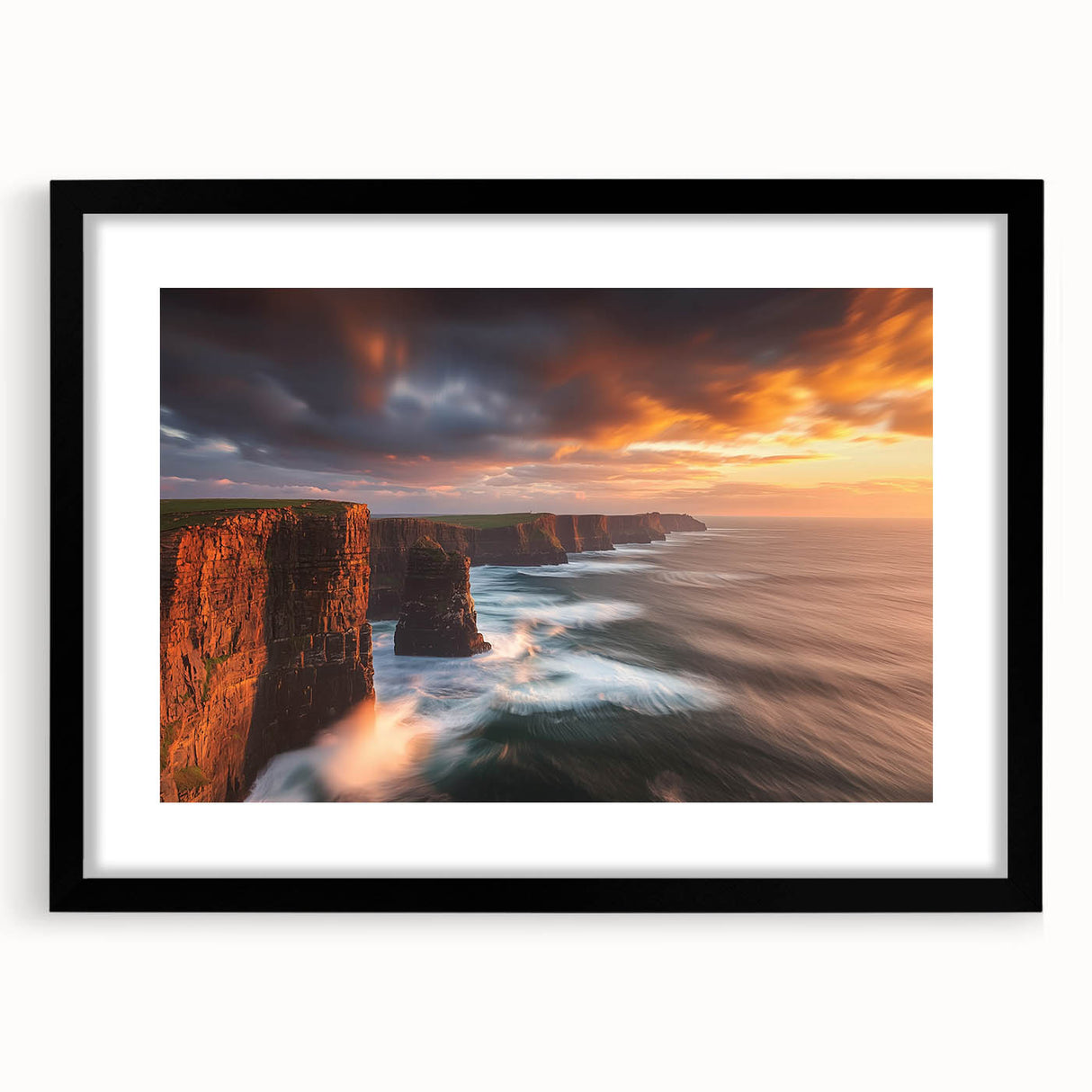 Black-framed landscape artwork depicting majestic cliffs under a vibrant sunset, featuring a white mat for a polished presentation, ideal for home decor.