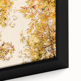 Close-up of a textured, black wall art piece featuring vibrant autumn leaves on a framed canvas, ideal for living room decor.