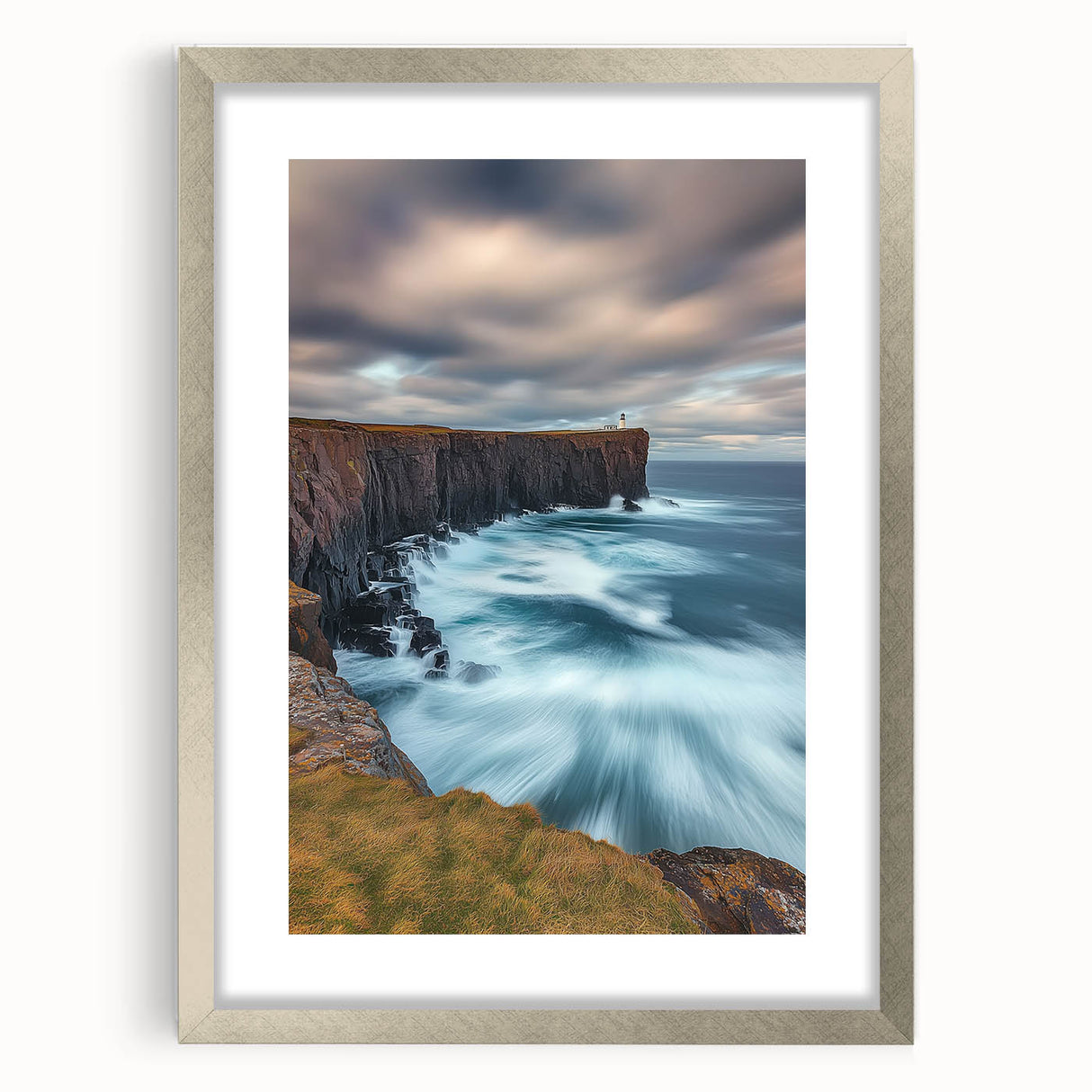 Silver-framed landscape artwork showcasing dramatic cliffs and serene scenery, complete with a classic mat for an elegant presentation, ideal for home decor.