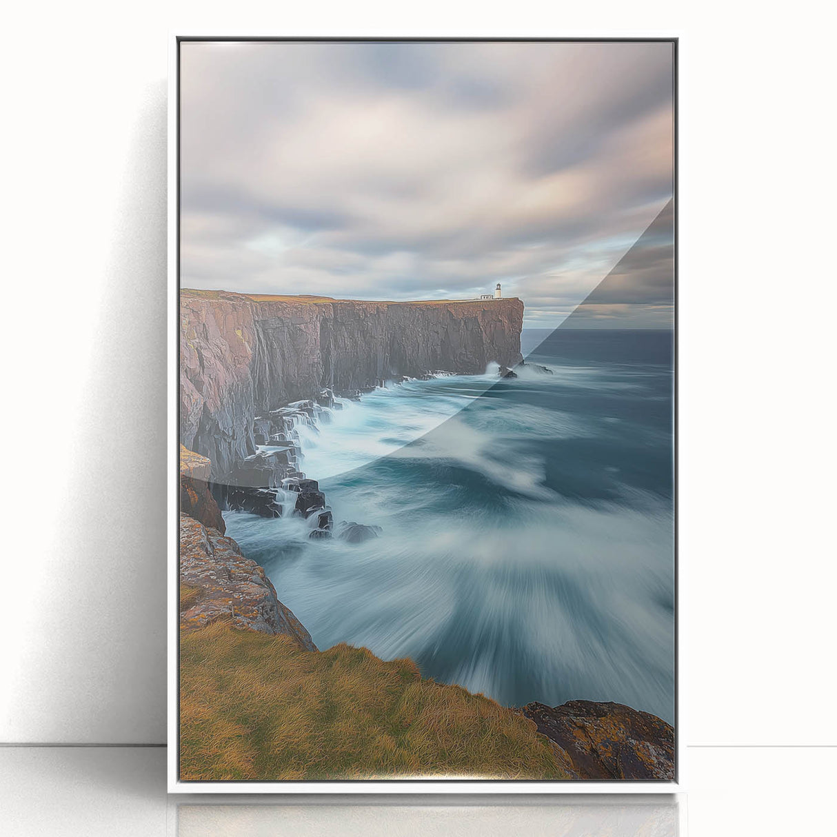 Framed acrylic landscape art showcasing dramatic cliffs under a vibrant sky, enhancing modern decor with its striking white frame and captivating details.