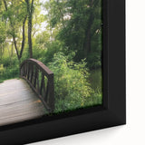 Close-up of a framed canvas depicting a serene landscape bridge scene, showcasing vibrant colors and fine details that enhance home decor aesthetics.