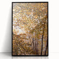 Large abstract wall art depicting autumn trees in muted orange and brown hues, framed in black acrylic.