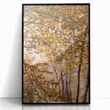 Large abstract wall art depicting autumn trees in muted orange and brown hues, framed in black acrylic.
