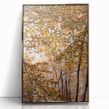 Mid-century modernist art depicting autumn trees on a silver-framed acrylic, in warm orange and yellow tones.