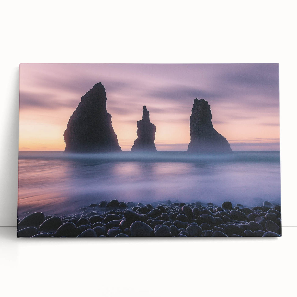 Stretched canvas artwork depicting colorful cliffs and landscapes, leaning against a wall, showcasing vibrant hues and dynamic textures perfect for home decor.