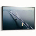 Framed canvas artwork showcasing a scenic landscape view of a bridge, featuring rich colors and intricate details, set against a black frame for a modern touch.