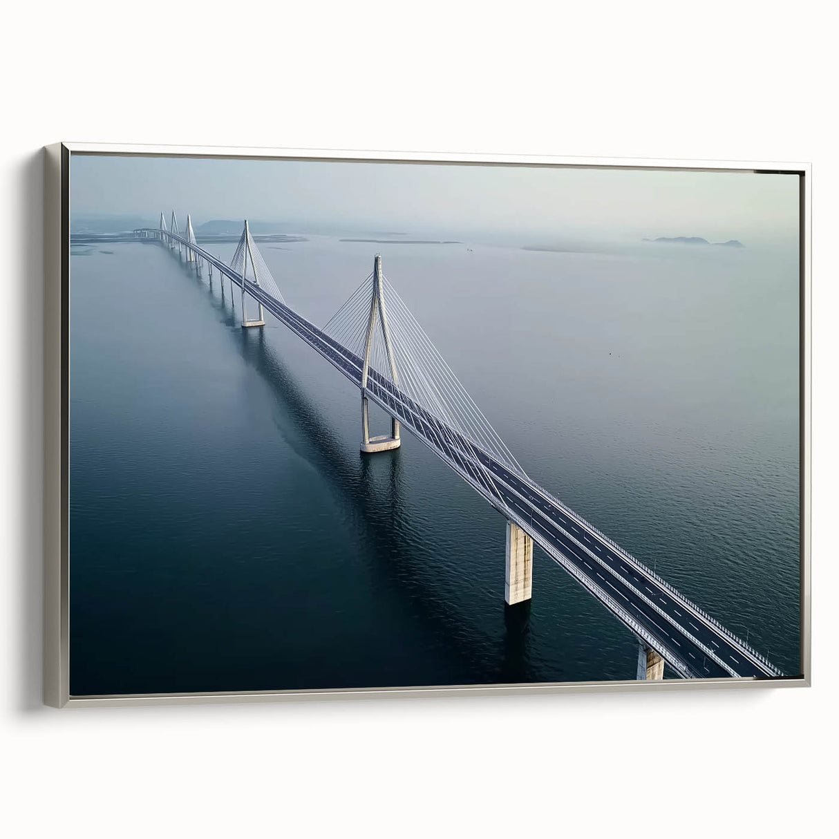 Framed canvas artwork depicting a serene landscape bridge scene with silver frame, ideal for home decor. Captures natural beauty and tranquility in vibrant colors.