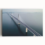 Landscape canvas print depicting a serene bridge surrounded by lush greenery under a clear blue sky. Ideal for home decor, enhancing tranquility in any space.