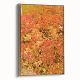 Framed canvas depicting a vintage-style landscape with autumn trees in vibrant orange and red tones.