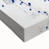 Close-up of an abstract splatter design on a stretched canvas, showcasing vibrant colors and intricate textures ideal for modern home decor. Perfect for art enthusiasts seeking unique wall art pieces to enhance interior spaces.