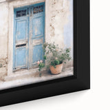 Close-up of a black framed canvas featuring a textured image of a colorful, Greek-style door, ideal for living room decor.