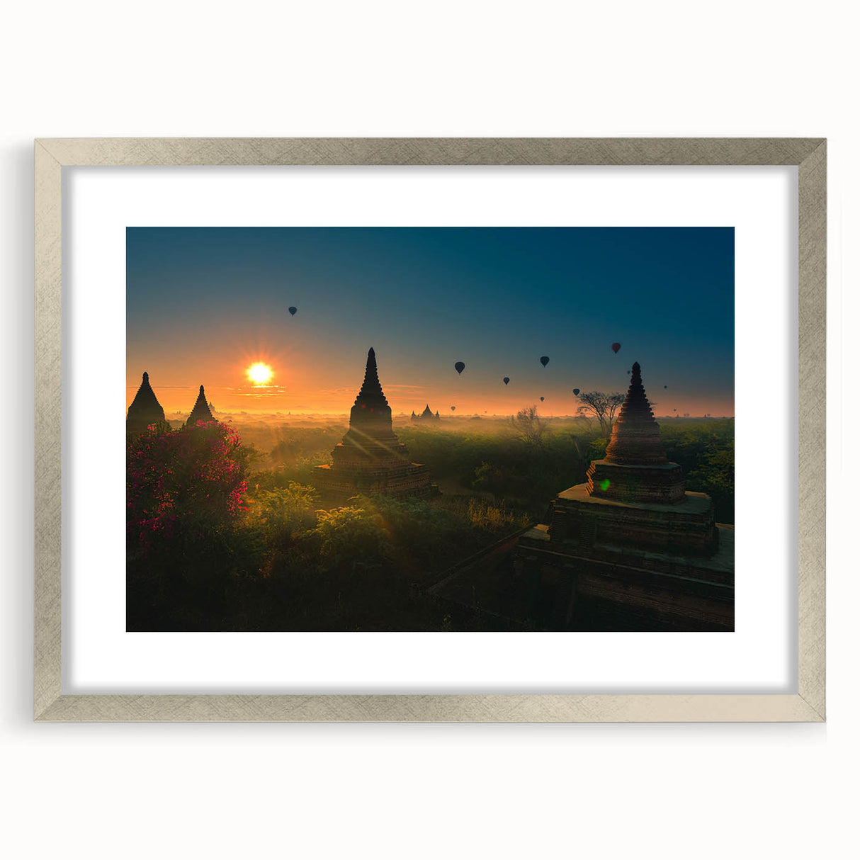 Textured art of a Myanmar landscape in muted earth tones on a framed silver mat, suitable for bedroom decor.