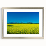 Textured abstract art print depicting Alberta scenery in muted earth tones, framed in silver, perfect for bedroom decor.