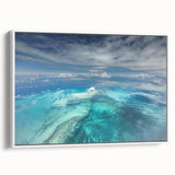 Vintage poster art of a Caribbean beach scene on framed canvas, featuring vibrant blue and white tones.
