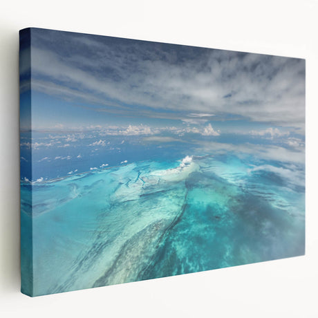 Large art depicting a serene Caribbean beach scene in soft blue and sandy tones on stretched canvas.