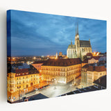 A stretched canvas print of the Charles Bridge in Prague, featuring muted gray and blue tones, ideal for kitchen wall art.
