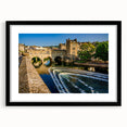 Extra large abstract art print depicting a colorful European cityscape in textured style, framed in black.