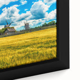 Extra large framed canvas featuring a textured depiction of a European scenery in black with colorful accents.