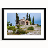Abstract art print of a colorful, textured European scenery in a black frame, ideal for living room decor.