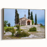 Framed canvas depicting a vintage-style landscape painting of southern France, in muted gold and black tones.