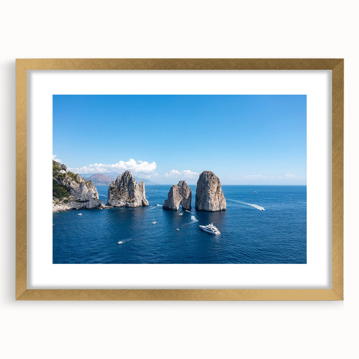 Abstract art print of Capri, Italy, in gold frame, featuring soft blue and white tones.