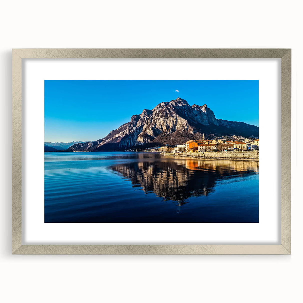 Extra large abstract print of Lake Como with textured details in muted blues and greens, framed in silver.