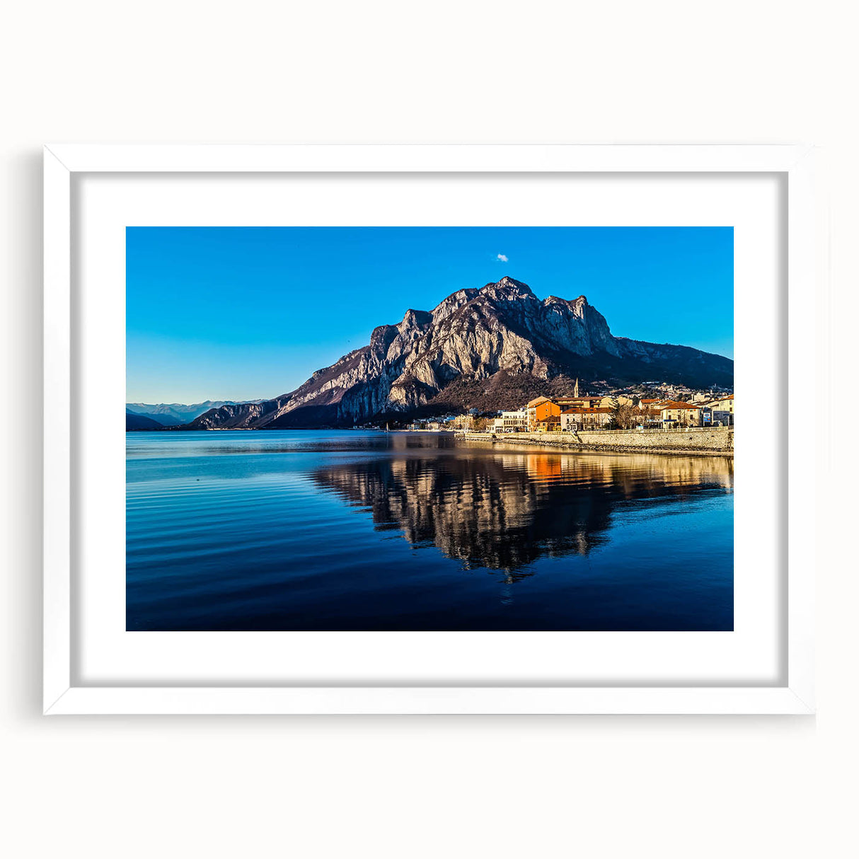 Textured art of Lake Como with abstract water reflections in muted blue shades, framed with a white mat.